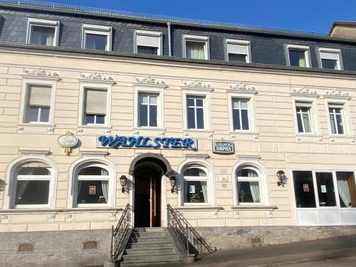 a building with a sign on the front of it at Hotel Wahlster in Saarbrücken