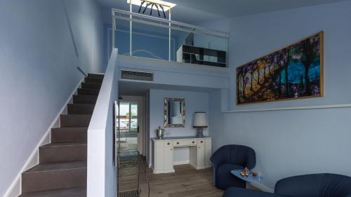 a living room with stairs and blue walls at Grand Hotel Menaggio in Menaggio