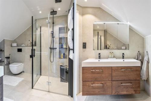 a bathroom with a sink and a shower at Luxury villa with pool in Bro