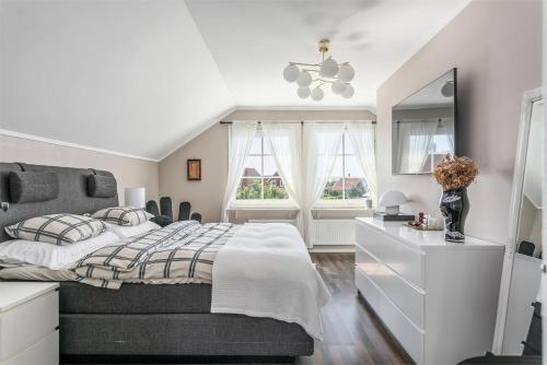 a bedroom with a bed with a dresser and a mirror at Luxury villa with pool in Bro
