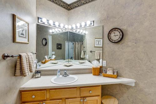 a bathroom with a sink and a large mirror at Lake View + Pool Access: Waterfront Ozark Escape! in Four Seasons