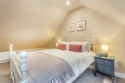 a bedroom with a white bed with red pillows at 2 Bed in Castleton oc-f34013 in Castleton