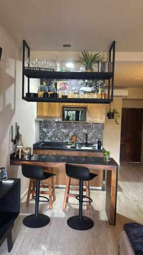 a dining room with a table and some chairs at Bokoba Condo Tulum Maia in Tulum