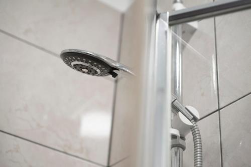 a shower with a shower head in a bathroom at Spacious City-Centre Apartment · Sleeps 4 in Nottingham