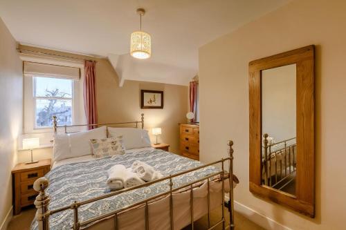 a bedroom with a bed and a mirror at 2 Bed in Chatton oc-r27205 in Chatton