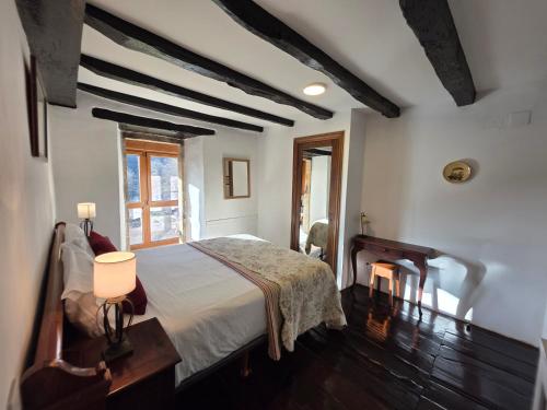 a bedroom with a bed and a table and a fireplace at CASA RURAL Urruska in Elizondo