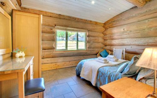 a bedroom with a bed in a log cabin at 4 Bed in Alston oc-nb575 in Alston
