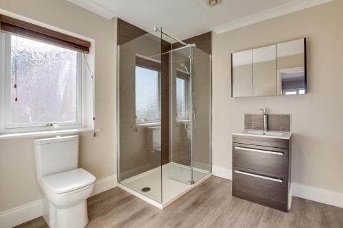 a bathroom with a shower and a toilet and a sink at 5 Bed in Seahouses oc-nb621 in Seahouses
