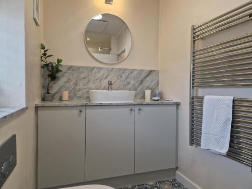 a bathroom with a white sink and a mirror at 2 Bed in Beadnell oc-gd1889 in Beadnell
