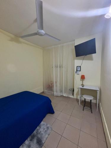 a bedroom with a blue bed and a desk at Lo de Julia in Formosa