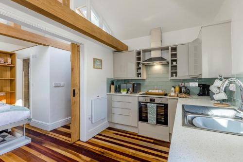 a kitchen with a sink and a stove top oven at 1 Bed in Cerrigydrudion oc-bow194 in Cerrig-y-Druidion