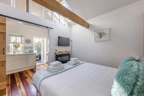 a white bedroom with a bed and a television at 1 Bed in Cerrigydrudion oc-bow194 in Cerrig-y-Druidion