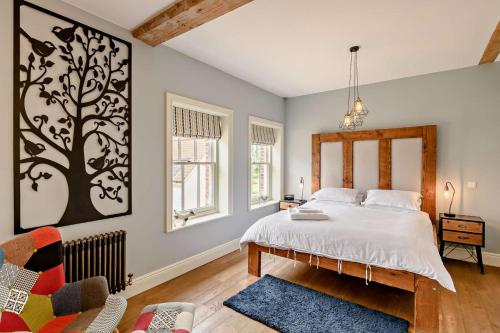 a bedroom with a bed and a tree picture on the wall at 2 Bed in Blythburgh oc-t27735 in Blyford