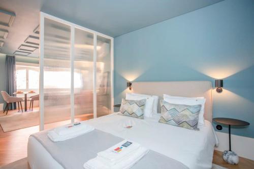a bedroom with a bed with two towels on it at Liiiving in Porto - Ribeira Design Apartment in Porto
