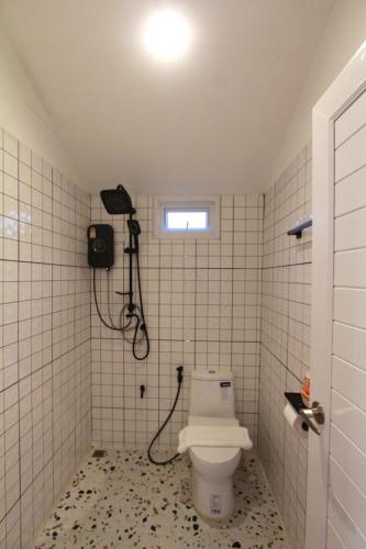 a bathroom with a toilet and a shower at Wawee Sunset, Doi Chang Chiang Rai in Ban Huai Khai
