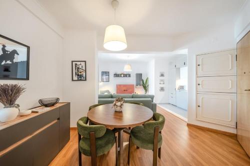 a kitchen and living room with a table and chairs at GuestReady - Charming Oeiras apartment in Oeiras