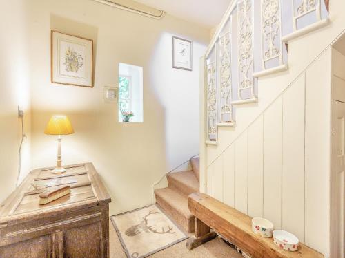a stairwell with a wooden table and a stair case at The Cottage in Slickly