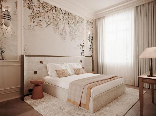 a bedroom with a bed and a large window at Relais d'Amboise - The Leading Hotels of the World in Amboise