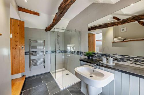 a bathroom with a sink and a glass shower at 1 Bed in Dyffryn Ardudwy oc-g29349 in Dyffryn