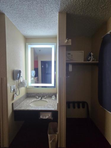 a bathroom with a sink and a mirror at Howard Johnson by Wyndham Williams in Williams