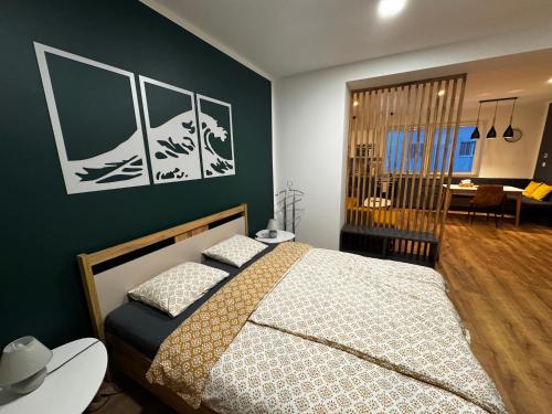 a bedroom with a bed and a green wall at Štúdio Sihoť - parkovanie a nabíjanie EV in Trenčín