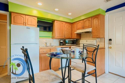 a kitchen with a table and chairs and a refrigerator at Windy Hill Villa A in Myrtle Beach