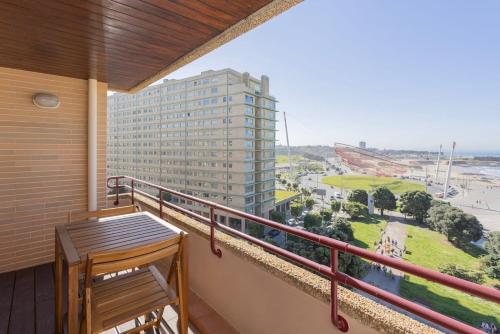 a balcony with a table and a view of a building at Liiiving in Matosinhos - Seaside Balcony Apartment in Porto