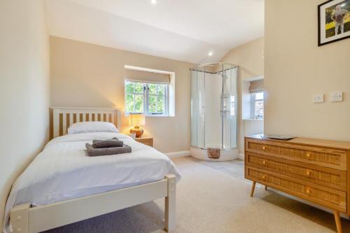 a bedroom with a bed and a shower and a dresser at 2 Bed in Oxborough oc-t29292 in Oxborough