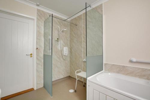 a bathroom with a shower with a glass door at 2 Bed in Attleborough oc-1277 in Old Buckenham