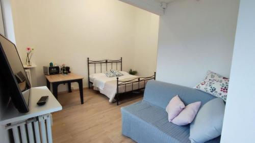 a living room with a couch and a bed at Torino Comfort 10 in Turin