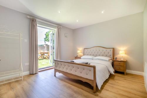 a bedroom with a large bed and a large window at 2 Bed in Oxborough oc-r29290 in Oxborough