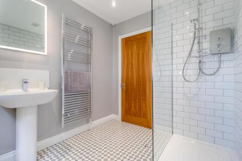 a white bathroom with a sink and a shower at 2 Bed in Oxborough oc-r29290 in Oxborough