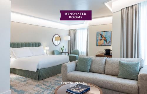 a hotel room with a bed and a couch at Crowne Plaza Porto by IHG in Porto