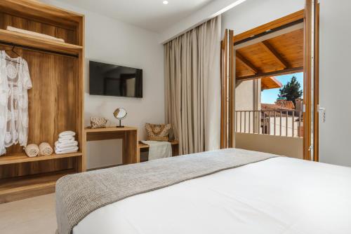 a bedroom with a white bed and a window at EMERALD Luxury Living in Syvota