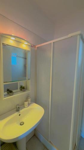 a white bathroom with a sink and a shower at Infinity View Villa Panoramic Aegean Siviri in Siviri