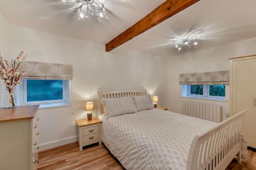 a bedroom with a white bed and two windows at 2 Bed in Shotley Bridge oc-h29037 in Shotley Bridge