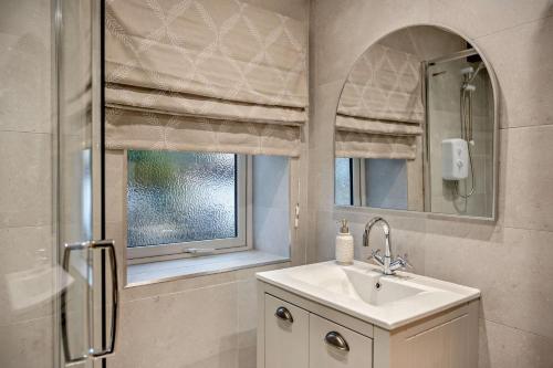 a bathroom with a sink and a mirror and a window at 2 Bed in Shotley Bridge oc-h29037 in Shotley Bridge