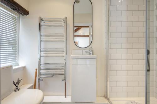 a bathroom with a shower and a sink and a mirror at 3 Bed in Appledore oc-f29064 in Appledore