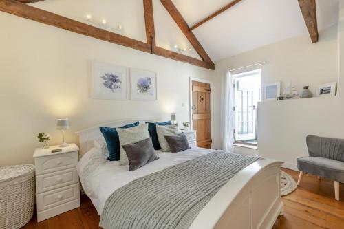 a bedroom with a large white bed with blue pillows at 3 Bed in Appledore oc-f29064 in Appledore