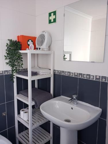 a bathroom with a sink and a mirror at Apartamentos São Sebastião in Évora