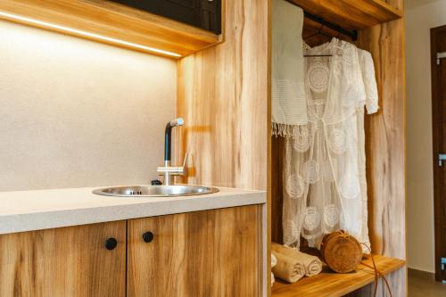 a bathroom with a sink and a curtain at EMERALD Luxury Living in Syvota