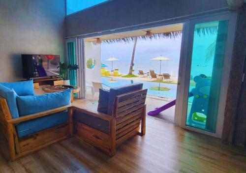 a living room with a view of the ocean at The Rock Samui Beach Resort in Lamai