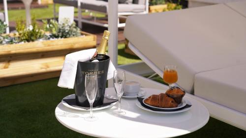 a table with a bottle of wine and a plate of food at Coral Los Alisios in Los Cristianos