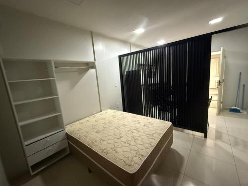 a small bedroom with a bed and a closet at Fitroom Apartment in Santarém