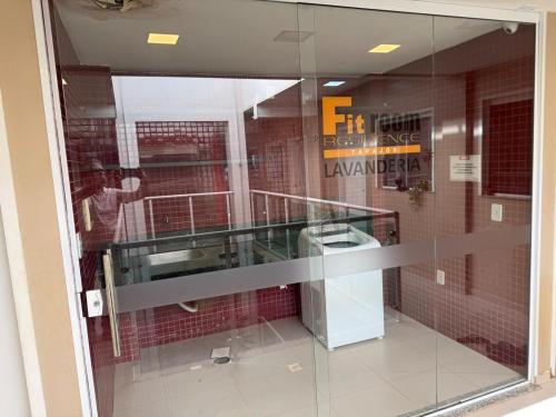 a glass window in a building with a man taking a picture at Fitroom Apartment in Santarém