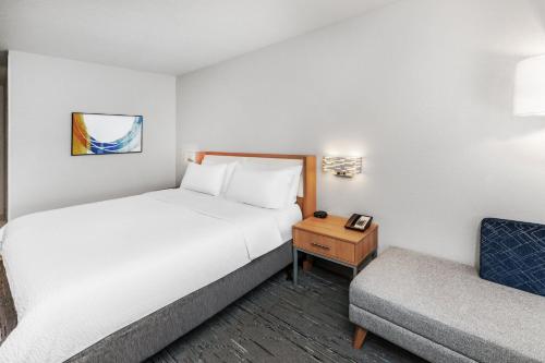 a hotel room with two beds and a chair at Holiday Inn Express Hotel & Suites Lonoke I-40 by IHG in Lonoke