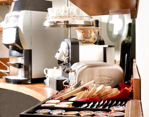 a counter with a tray of cupcakes and a mixer at Hotel Ca' D'Oro - WENICE Deep Culture in Venice
