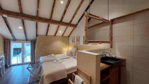 a bedroom with a bed and a sink in a room at Refuge des Sottais in Burg-Reuland