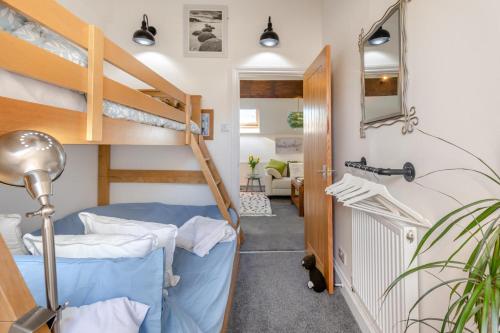 a room with two bunk beds and a hallway at 2 Bed in Horns Cross oc-l29271 in Bucks Mills