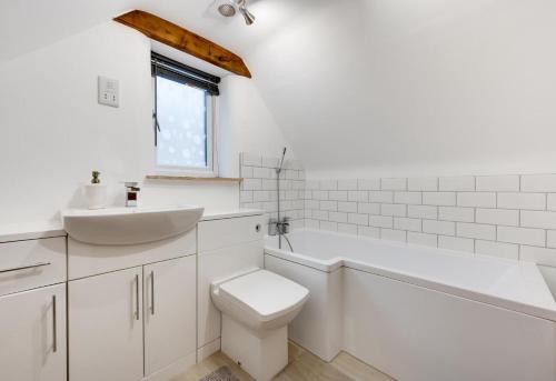 a white bathroom with a toilet and a sink at 1 Bed in Ashover oc-dclhil in Ashover